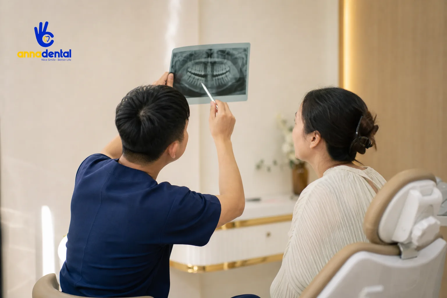 Bác sĩ đang giải thích phim X-quang cho bệnh nhân bọc răng sứ